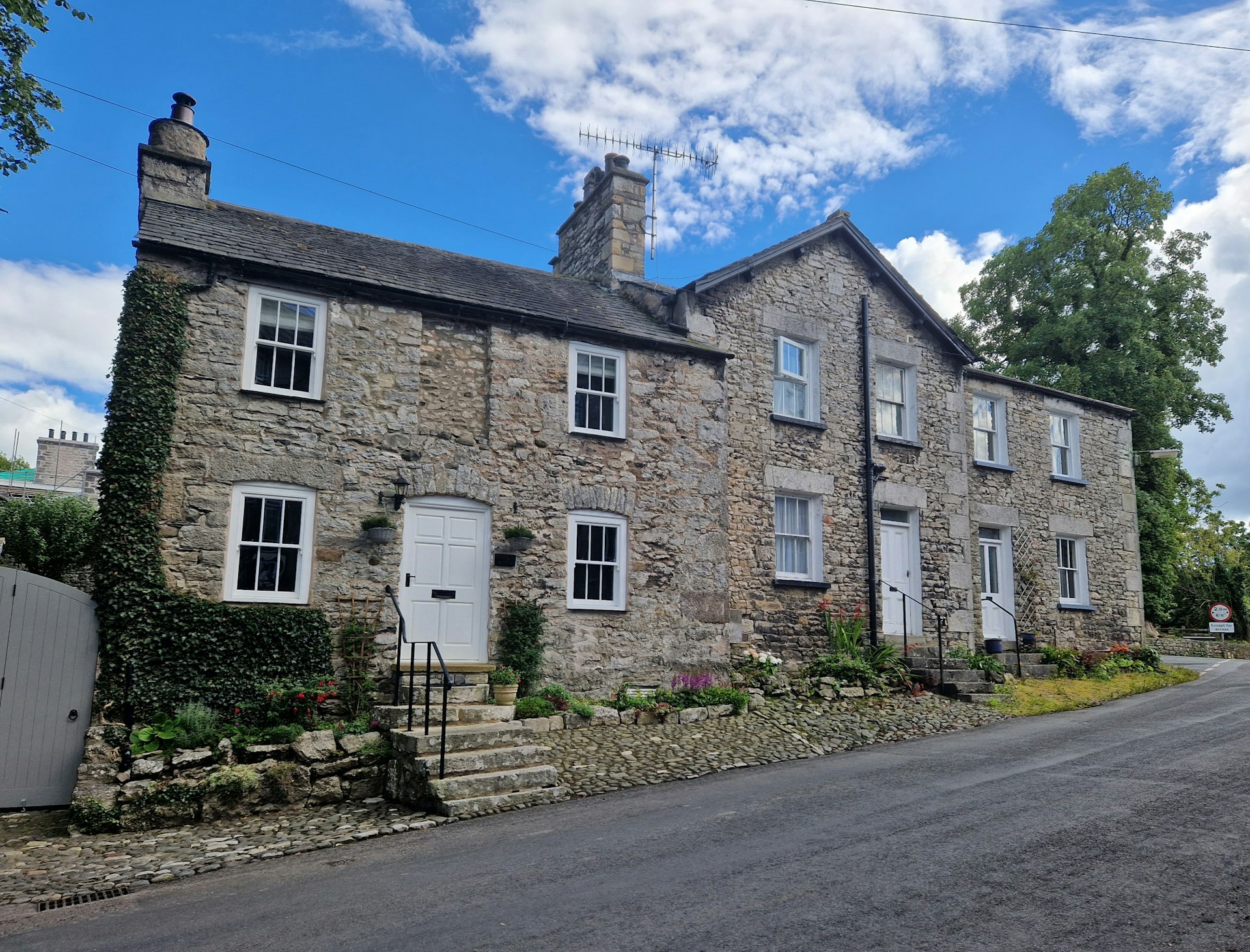 a stone building with a driveway